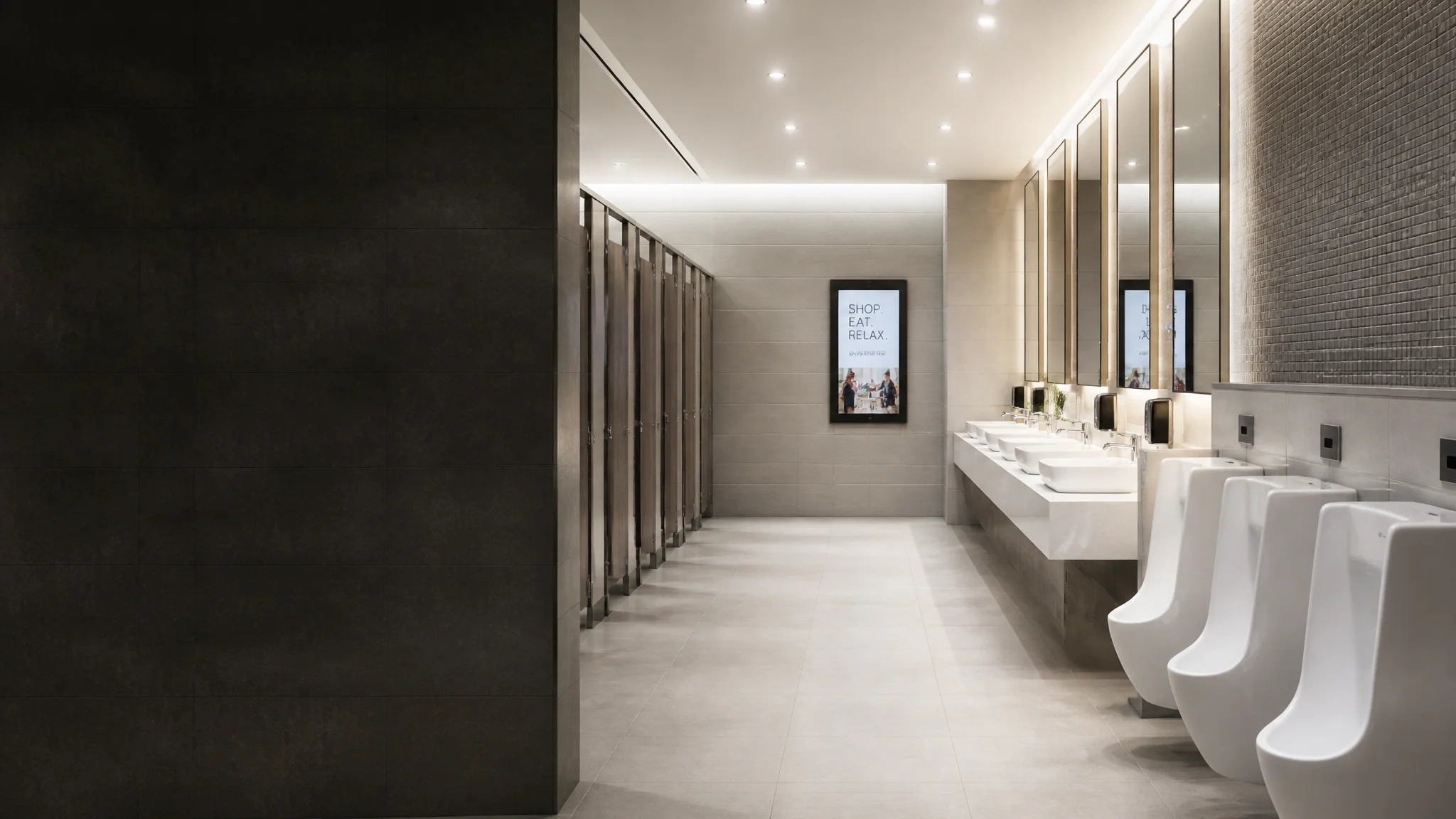 Commercial public washroom with multiple basins, stalls and urinals